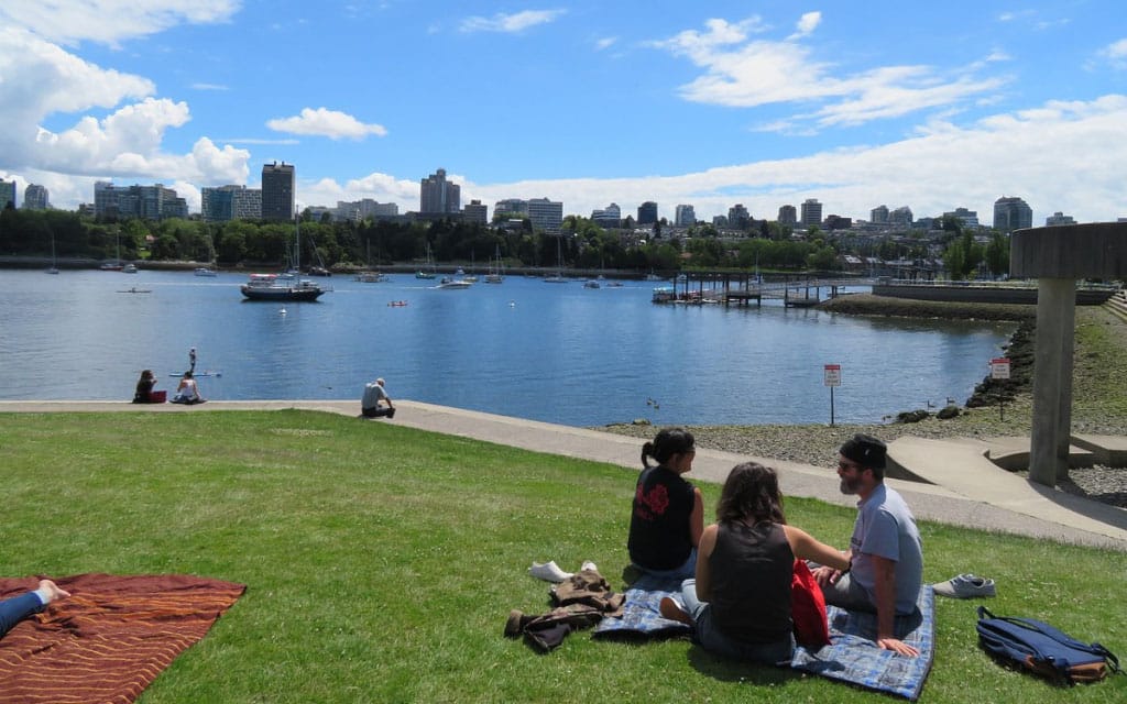 people having a picnic at harbour green park with a view of the lake and what to do in vancouver before a cruise
