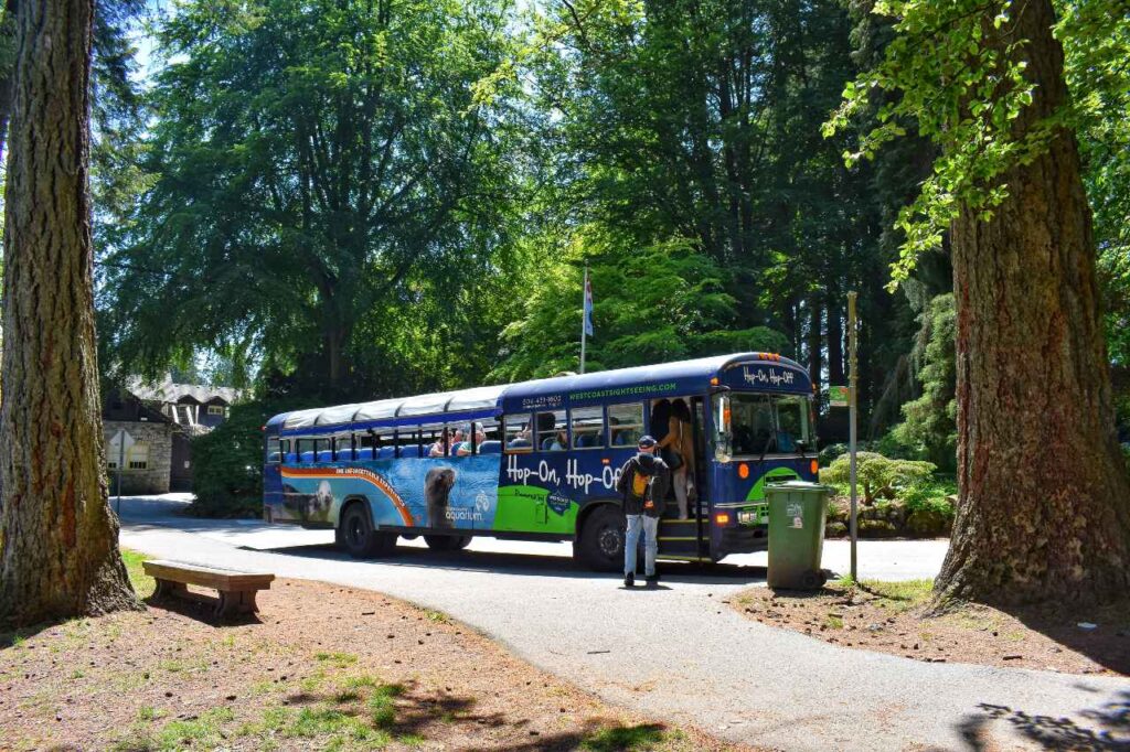 tourists boarding a vancouver bus tour in stanley park