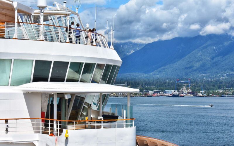cruise passengers looking out at the vancouver coast mountains