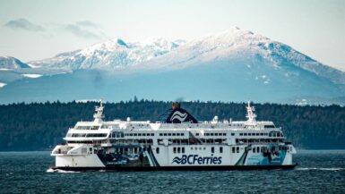 vancouver victoria ferry underway with snowy mountain backdrop