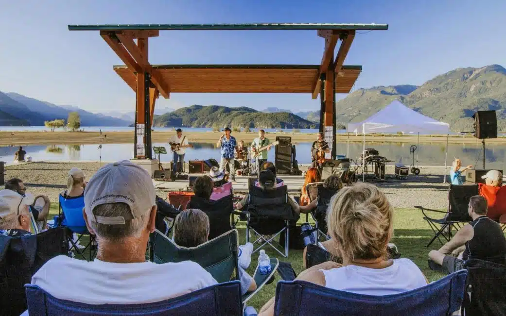 couple watching a band along the beach at harrison bc