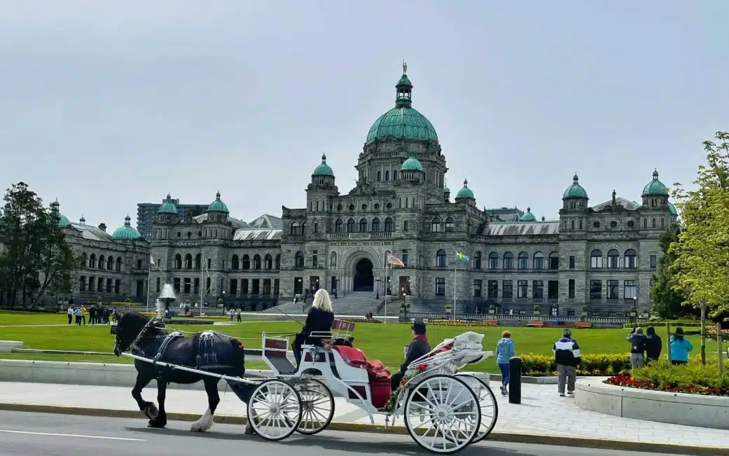 the bc legislature parliament buildings in victoria bc with horse carriage