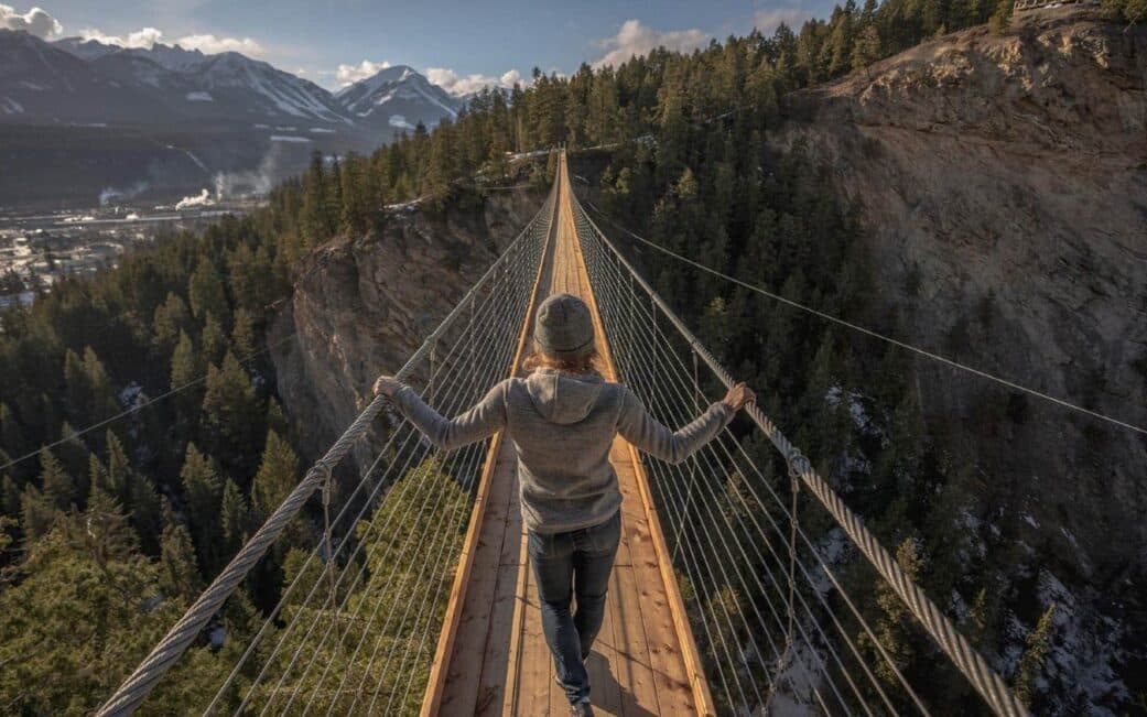 A woman marvels at the views from the Golden Skybridge in Golden, BC.