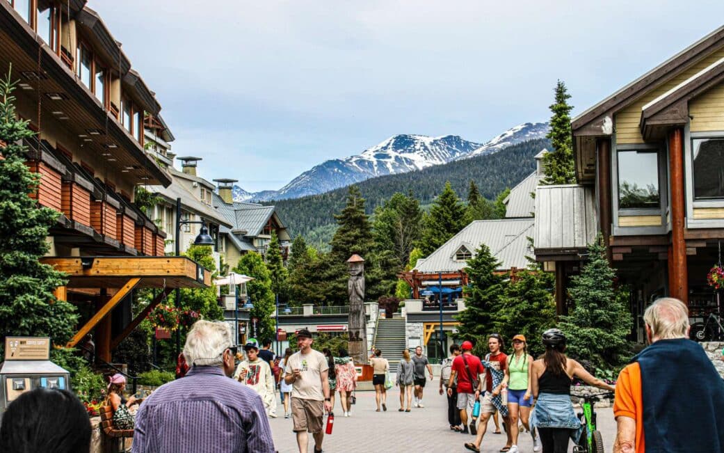 A crowd wanders through the village after a road trip from Vancouver to Whistler.