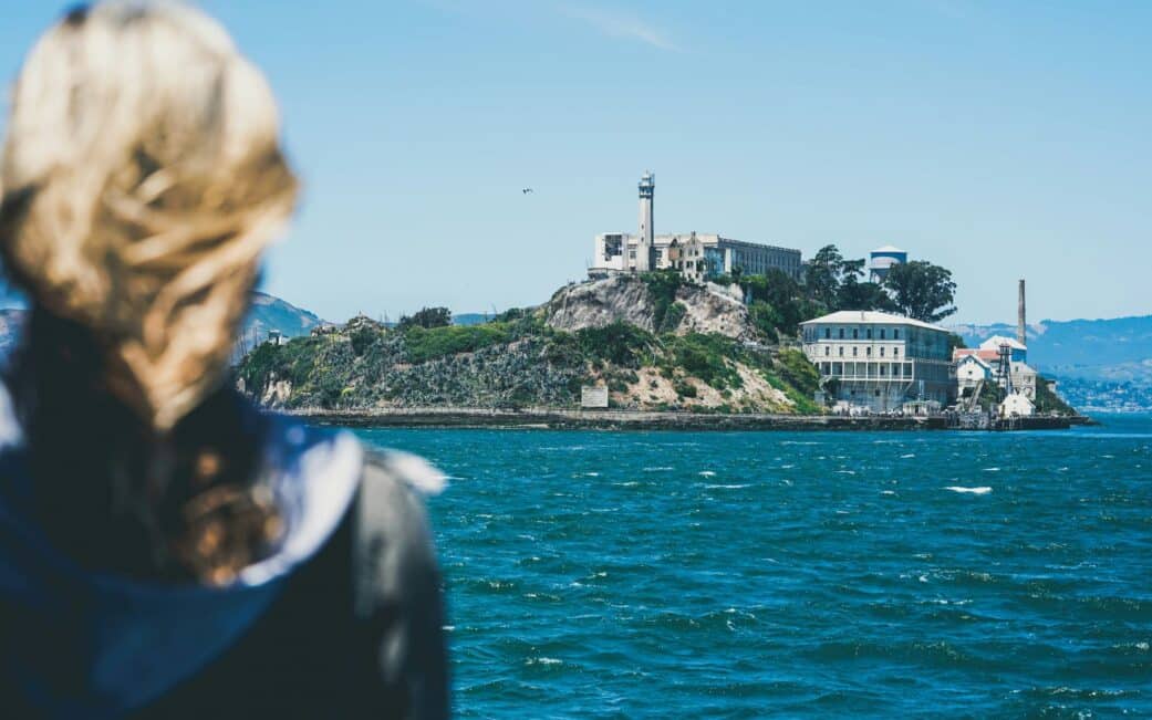 A woman checks out Alcatraz on a San Francisco Bay cruise.