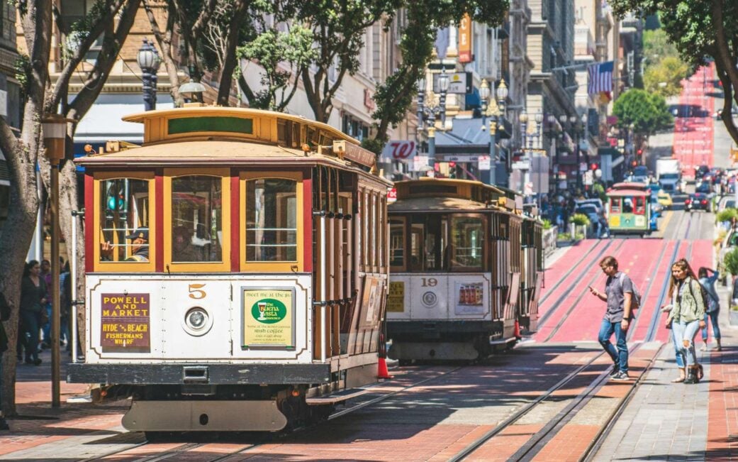 A cable car travels down the hill on a Vancouver to San Francisco road trip.