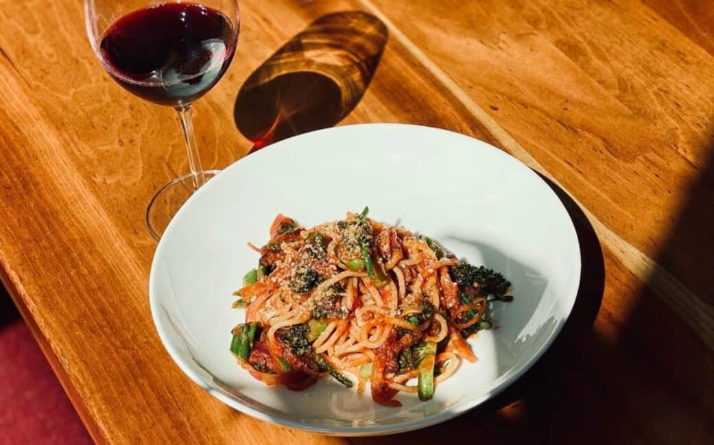 A plate of pasta and red wine at Nook, in Vancouver's West End.